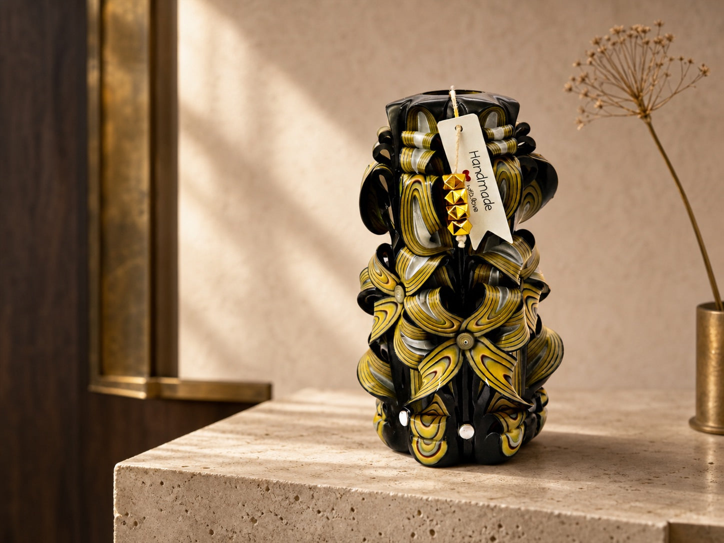 A black and gold Luv Crafts carved candle styled as an interior object